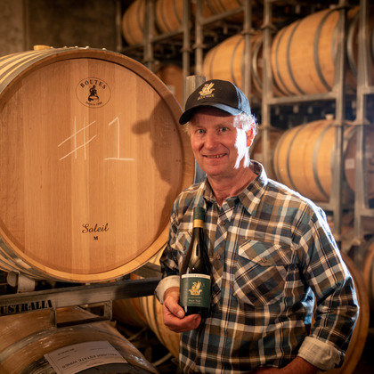 Winemaker Guy McMaster holding a bottle of our Estate Pinot Noir